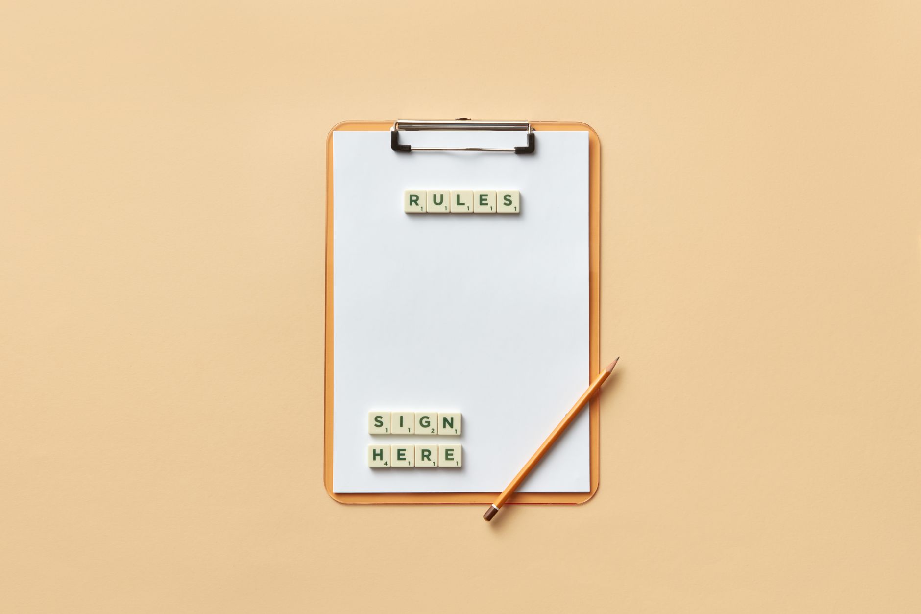 pencil and letter tiles on a clipboard